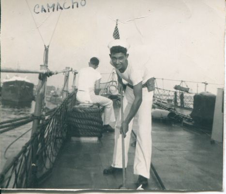 Luis Camacho swabbing the desk of a destroyer in his early US Navy Career Press Enter to Activate this item.
