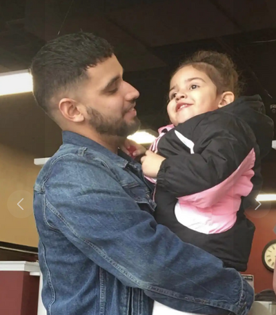 Nicholas holding his baby girl. Press Enter to Activate this item.