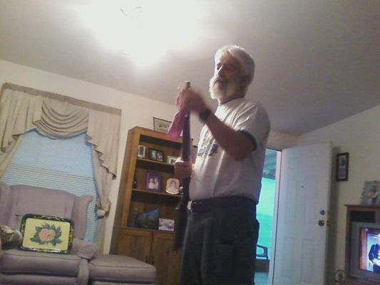 Cleaning his gun