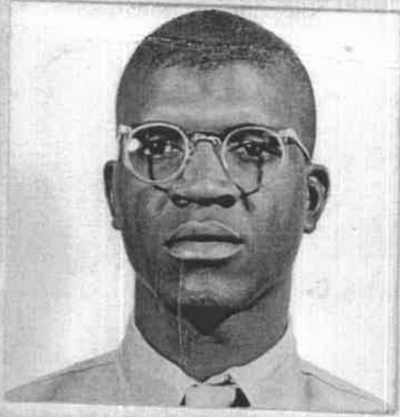 A young African American man wearing glasses and a Marine Corps dress shirt and tie.
