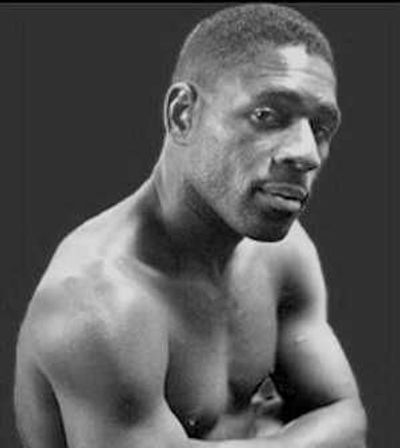 A African American boxer, posing without a shirt.