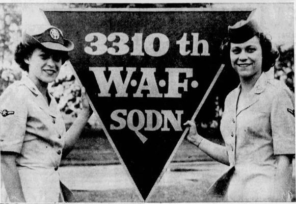 Alanna Maddox and another servicemember standing in front of a sign. Press Enter to Activate this item.