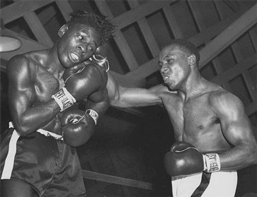 George Benton landed a punch on an opponent in the boxing ring.