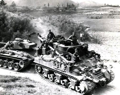 Picture of tanks on an unmaintained road.