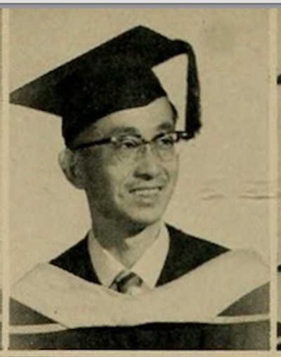 Headshot photograph of Fred Suzuki with a graduation hat on his head.