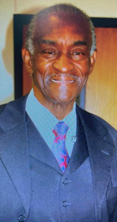 Photo of John Blue in a blue suit and tie. Press Enter to Activate this item.